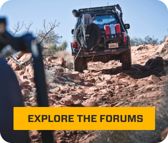 An Overland Bound truck climbing up a rocky hill.